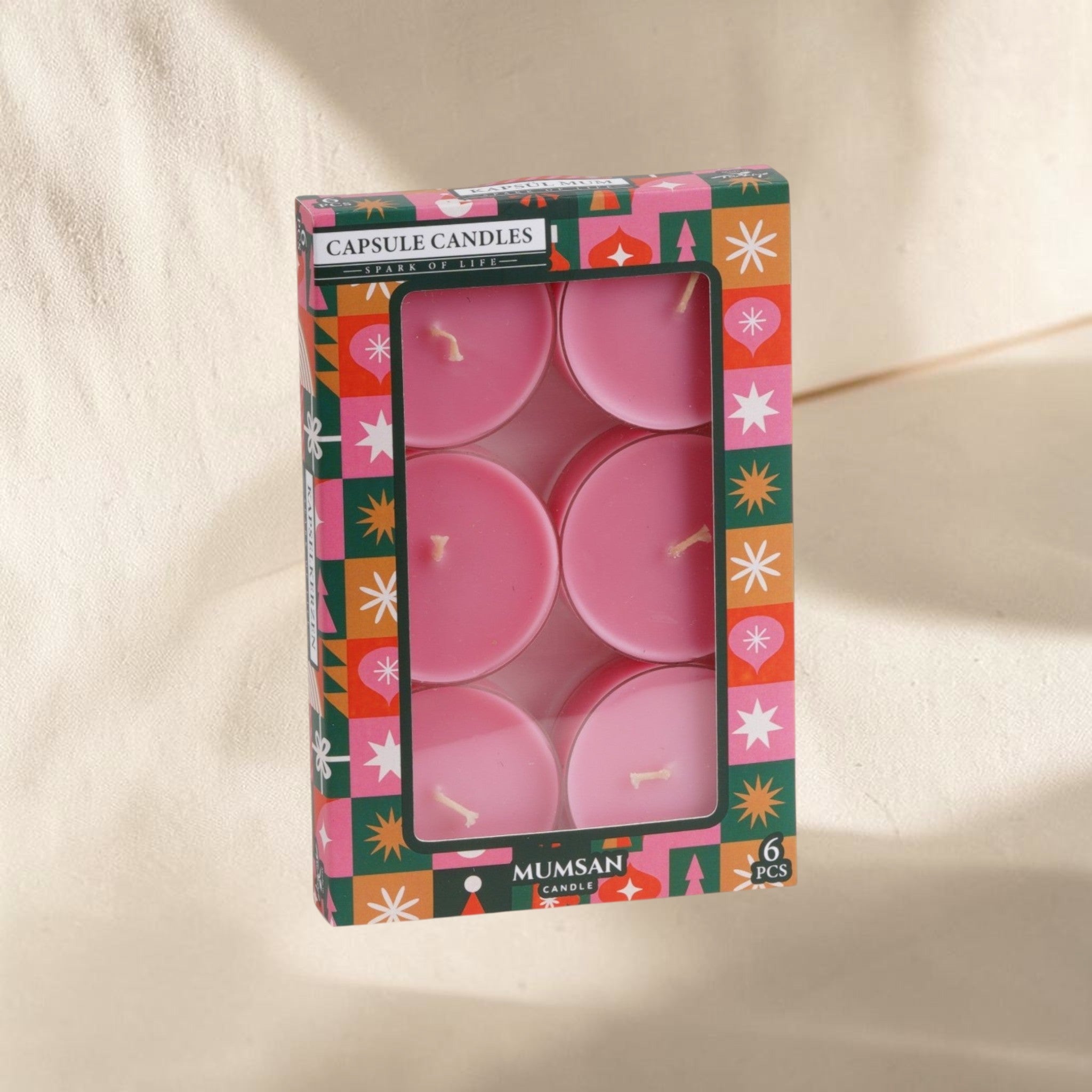 MUMSAN CANDLE 6'lı şeffaf pembe renkli, aromalı kapsül mum seti. Her biri 42 gr, 8 saat yanma süreli.
